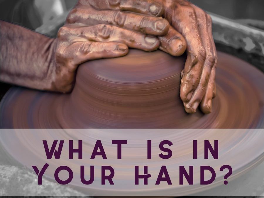 Hands working on pottery wheel